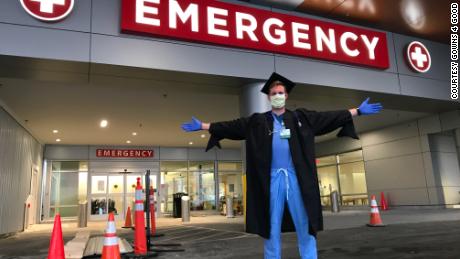 Nathaniel Moore wearing his cap and gown outside of University of Vermont Medical Center in Burlington, Vermont.